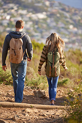 Image showing Vacation, hiking and couple walking in nature for holiday, travel or adventure outdoor with backpack. Rear view, man and woman trekking in the countryside on journey, date and exploration together