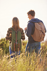 Image showing Spring, backpack and couple in nature, adventure and bonding for holiday, vacation and trip to Amsterdam. Outdoor, man and woman together for love in field for hiking of girl and male person