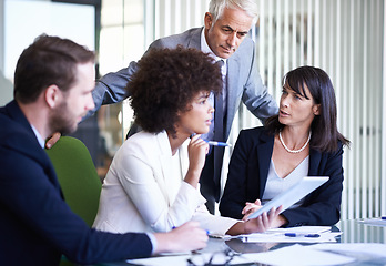 Image showing Team, tablet and business people research, discussion and brainstorming online strategy in office. Collaboration, technology and diverse group planning project, CEO or serious consultants in meeting