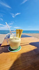 Image showing Drink on wooden table by the ocean
