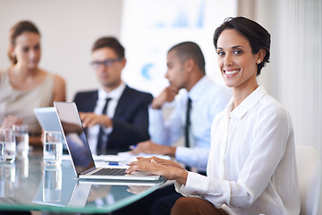 Image showing Woman, office and smile in meeting with laptop to brainstorm for contract, paperwork and teamwork or collaboration. Business people, boardroom and table with strategy, feedback and company growth.