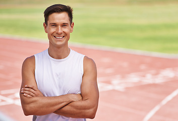 Image showing Athlete, portrait or positive for fitness on stadium, arms crossed or commitment to wellness as running professional. American, man or face for confident in sport, outdoor or training for health body