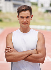 Image showing Athlete, portrait or serious for fitness on stadium, arms crossed or commitment to wellness as running professional. American, man or face for confident in sport, outdoor or training for health body