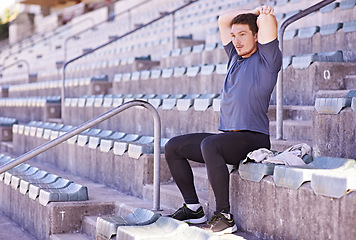 Image showing Athlete, stretching and arms in sports stadium with man for race, competition or marathon. Male runner, wellness and fitness for training, warm up exercise or cardio workout in track and field arena