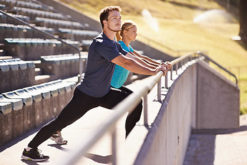 Image showing Sports, legs and couple stretching in stadium for race, marathon or competition training for health. Fitness, wellness and runner athletes with warm up exercise for running cardio workout on track.