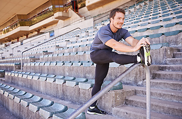 Image showing Fitness, legs and man stretching in stadium for race, marathon or competition training for health. Sports, energy and male runner athlete with warm up exercise for running cardio workout on track.