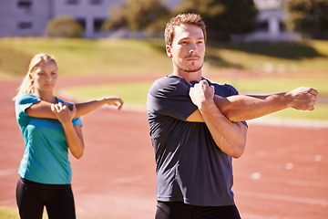 Image showing Fitness, arms and couple stretching in stadium for race, marathon or competition training for health. Sports, wellness and runner athletes with warm up exercise for running cardio workout on track.