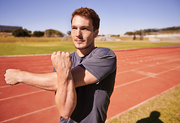 Image showing Fitness, arms and man runner stretching in stadium for race, marathon or competition training for health. Sports, vision and male athlete with warm up exercise for running cardio workout on track.