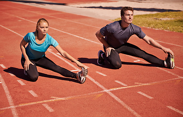 Image showing Training, legs and couple stretching in stadium for race, marathon or competition for health. Sports, fitness and runner athletes with warm up exercise for running cardio workout on outdoor track.