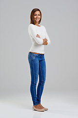 Image showing Portrait, confidence and happy woman in studio for fashion isolated on a white background mockup space. Arms crossed, young person and student in casual clothes, jeans or trendy style in Argentina