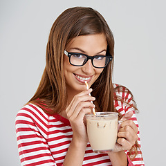 Image showing Woman, portrait and milkshake drinking in studio or sweet beverage for weekend relax, dessert or grey background. Female person, glasses and straw for chocolate smoothie, mockup space or happiness