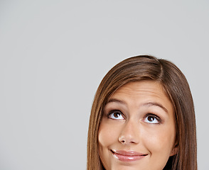 Image showing Studio, head and closeup with smile, thinking and mockup for idea or vision. Woman, planning and happy with optimism, positive and hopeful for future contemplating isolated on white background