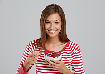 Image showing Woman, bowl and smile with studio, berries and happiness for health and wellness. Person, diet and nutrition with fruit, snack and organic salad for hungry or eating isolated on white background