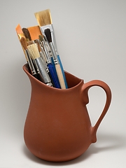 Image showing artistic brushes in a ceramic pot