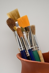 Image showing artistic brushes in a ceramic pot 