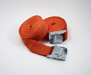 Image showing two orange fastening straps on white