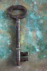 Image showing old rusty big key key on copper surface