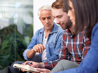 Image showing Creative, team and CEO in office, notebook and schedule by man with pen for design project. Boss, senior and male person as mentor to employees, woman and girl listen to teaching and learning