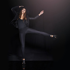 Image showing Portrait, fashion and balance with woman on black background in studio for clothing dance. Leather, model and outfit with confident young person in dark clothes for chic, edgy or trendy style