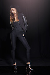 Image showing Classic fashion, thinking and young woman in studio on black background with flare for classy chic. Leather, model and vision with confident person in dark or trendy clothes outfit for style