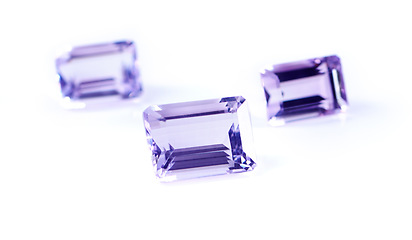 Image showing Gemstone, jewel and amethyst in studio with isolated white background for natural resource, baguette and sparkle for luxury. Rock, purple crystal and reflection in closeup for shine, glow and mineral