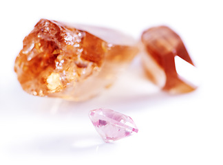 Image showing Gemstone, citrine and pink diamond in studio with isolated white background for natural resource, jewel and sparkle for luxury. Rock, crystal and reflection in closeup for shine, glow and mineral