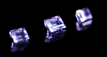 Image showing Rock, jewel and amethyst in studio with black background for natural resource, baguette and sparkle for luxury. Gemstone, purple crystal and reflection in closeup for shine, glow and mineral