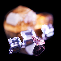 Image showing Gemstone, pink diamond and amethyst in studio with isolated black background for natural resource, jewel and sparkle for luxury. Rock, crystal and reflection in closeup for shine, glow and mineral