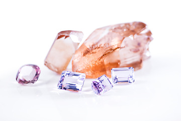 Image showing Rock, amethyst and pink diamond in studio with isolated white background for natural resource, jewel and sparkle for luxury. Gemstone, crystal and reflection in closeup for shine, glow and mineral