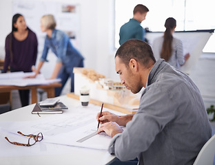 Image showing Man, architect and drawing on blueprint at desk for construction project, building or planning in startup office. Creative, design and serious engineer with pencil on paper for measurement on sketch