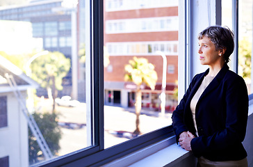 Image showing Vision, thinking and mature businesswoman at window in office with idea, opportunity and professional at work. Reflection, memory and woman planning future growth, ambition and inspiration for career