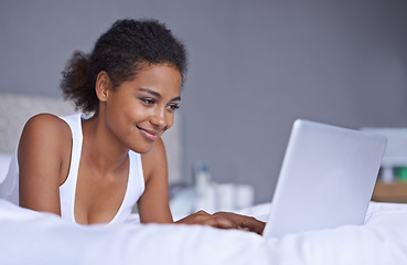 Image showing Black woman, laptop and bed to relax on social media, internet or email as digital communication. Happy, female blog writer or computer as typing to browse, search or online news on web network