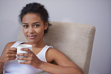 Image showing Relax, portrait and calm woman with coffee on a chair for morning reflection, peace or insight in her home. Smile, face and female person with tea cup in a living room with rest, break or me time