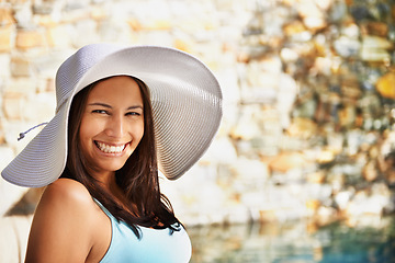 Image showing Pool, smile and portrait of woman with sun hat for summer holiday, travel and relax at luxury resort. Happy, female person and vacation at retreat for weekend, break and adventure for wellness