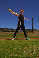 Image showing Man, athlete and javelin or sport exercise for competition on grass for workout fitness or outdoor, strength or training. Male person, challenge and target in arena for performance, aim or practice