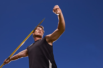 Image showing Man, athlete and javelin throw for competition sport with arm strength for performance practice, challenge or blue sky. Male person, stick and target aim or outdoor activity, professional or champion
