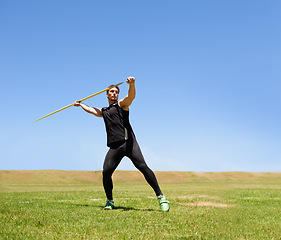 Image showing Man, workout and javelin throw or sport competition on grass for athlete fitness or outdoor, strength or training. Male person, challenge and target strong or exercise performance, aim or wellness