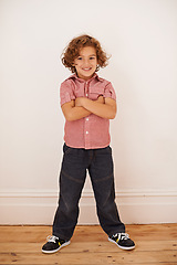 Image showing Boy, child and confident in portrait for style, smile and proud for casual outfit or clothes in home. Male person, kid and cool fashion by wall background, happy and mockup space in living room
