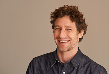 Image showing Mature man, portrait and laugh in studio, comedy and funny memory to remember on brown background. Happy male person, positive and comic for silly or goofy joke, smile and humor on mockup space