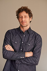 Image showing Mature man, portrait and confident in studio, smile and denim or casual fashion on brown background. Happy male person, positive and cool clothes or style, proud and satisfaction for aesthetic