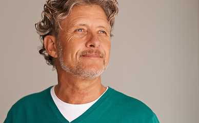 Image showing Mature man, thinking and smile in studio, peace and memory to remember on brown background. Happy male person, positive and planning for wellness in retirement, calm and daydreaming on mockup space