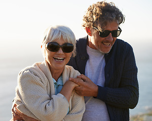 Image showing Happy, nature and senior couple with love for travel, tourism and holiday in retirement together. Coast, field and elderly people with smile for summer vacation, bonding and sunset walk in California
