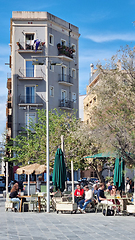 Image showing BARCELONA, SPAIN - APRILL 2, 2024: Group of people sitting at tables in front of a tall building