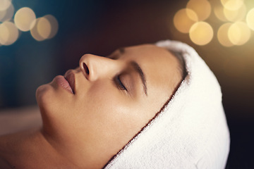 Image showing Woman, relax and wellness in spa for beauty, therapy and cosmetic treatment with eyes closed for break and skincare. Young person with towel on head for peace, holistic and hygiene care on bokeh