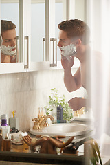 Image showing Man, cream for shaving and grooming in bathroom, skincare and beauty with morning routine at sink. Skin health, cosmetic foam or soap for hygiene, dermatology and hair removal with facial at home