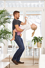 Image showing Man, girl kid and dancing with happiness at home, father and daughter time with love and trust. Single dad, family and bonding with rhythm and moving, playful dip with music and energy in living room