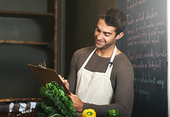 Image showing Kitchen, restaurant and man with clipboard for cooking, service and chef skills for supper. Fine dining, cafe and person with notes, paper and write for stock, inventory and ingredients for meal prep