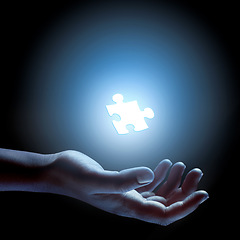 Image showing Puzzle, piece and abstract solution in hand for problem solving, challenge and planning with strategy. Jigsaw, games or shape of idea to glow in light of dark and search for innovation in business