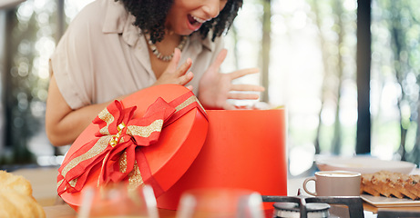 Image showing Woman, excited and open gift box in home with surprise, romance and love in marriage on valentines day. Lady, nervous and shake a red present for anniversary, care and gratitude by kitchen counter