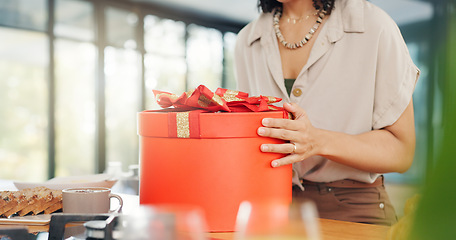 Image showing Woman, excited and open gift box in home with surprise, romance and love in marriage on valentines day. Lady, nervous and shake a red present for anniversary, care and gratitude by kitchen counter